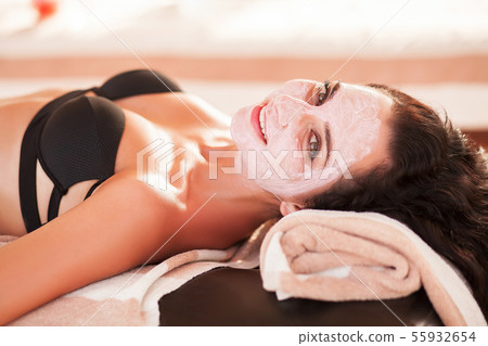 Spa mask. Beautiful woman get spa mask on the sunny beach in spa salon outdoor. High quality. Scin 55932654