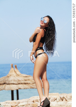 young beautiful blonde girl with a good figure in a shirt with red lips make-up posing in a pool of young beautiful blonde girl with a good figure in a shirt with red lips make-up posing in a pool of 55933717