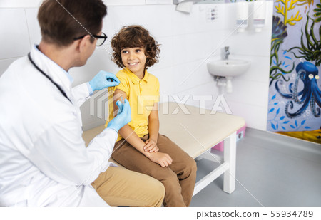 Boy is having fun during vaccination stock photo 55934789