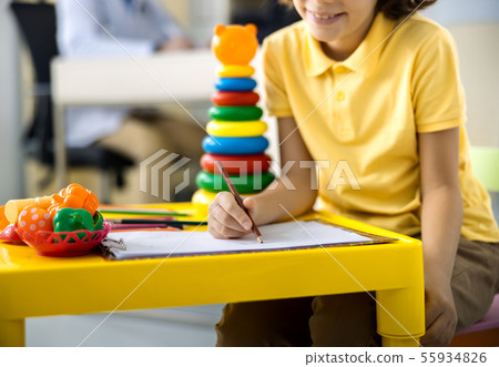 Joyful kid drawing in clinic stock photo 55934826
