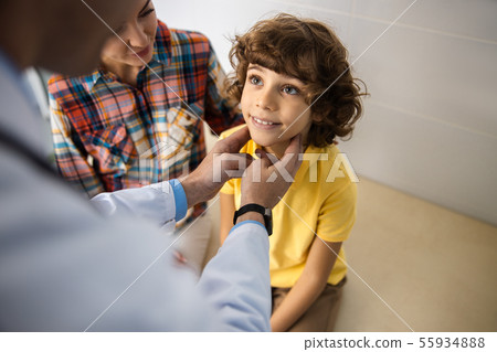 Happy boy is visiting pediatrician with mother stock photo Happy boy is visiting pediatrician with mother stock photo 55934888