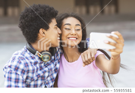 Young loving couple making selfie on smartphone camera 55935581