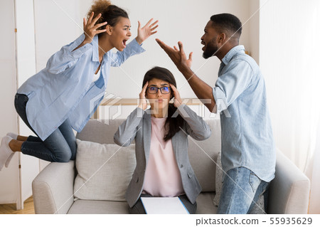 Shocked Psychotherapist Watching Black Spouses Shouting And Blaming Each Other 55935629