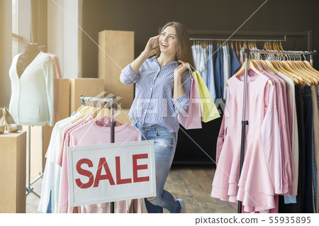 Shopping woman with bags talking on the phone 55935895