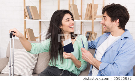 Happy couple with passports and tickets at home 55935982