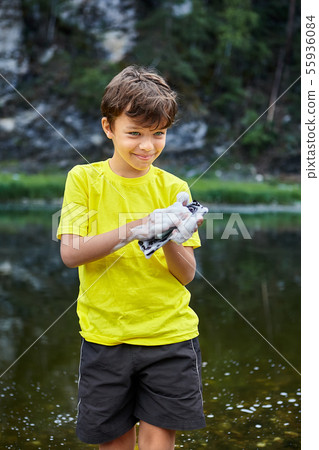 Boy destroys device with water. Boy destroys device with water. 55936084