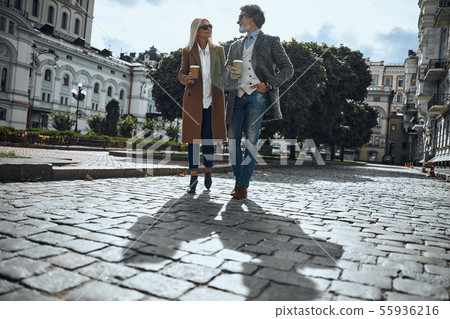 Pleasant stroll with coffee to go stock photo 55936216