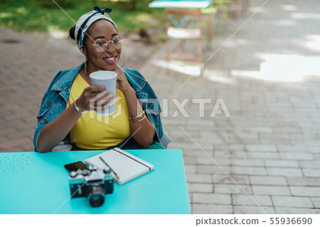 Happy young female holding paper cup in hand Happy young female holding paper cup in hand 55936690