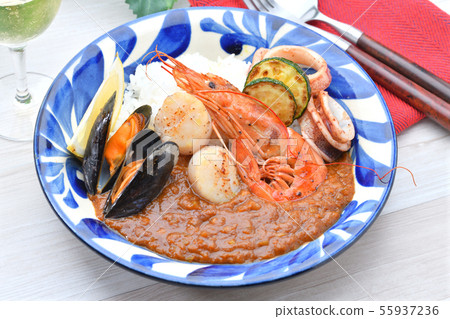 Summer seafood curry. Served with red shrimp, mussels, scallops, squid and zucchini. 55937236