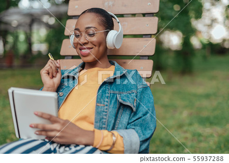 Young african american woman writing in notepad 55937288
