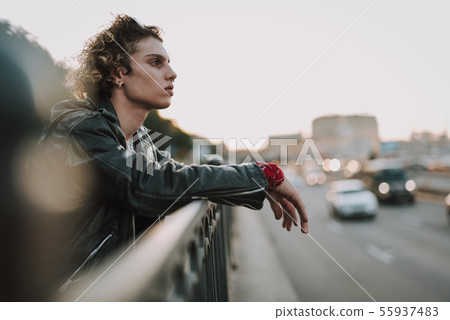 Pensive young man on the bridge alone 55937483