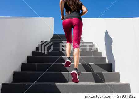 Stairs running woman doing run up on staircase - female runner Stairs running woman doing run up on staircase - female runner 55937822