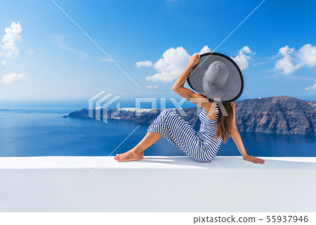 Europe vacation destination luxury Oia hotel woman 55937946