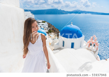 Santorini travel Oia stairs tourist woman walking 55937948