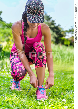 Fashion running activewear runner girl tying shoes Fashion running activewear runner girl tying shoes 55938034