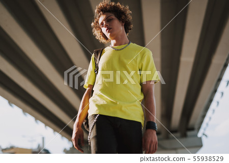 Calm young man in street style with backpack 55938529