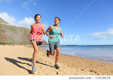 Runners running on beach - jogging couple Runners running on beach - jogging couple 55938678