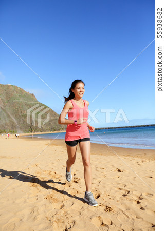 Runner sports athlete running woman on beach 55938682