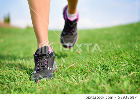Runner athlete feet running on grass fitness woman Runner athlete feet running on grass fitness woman 55938687