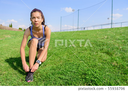Sporty woman runner preparing for running Sporty woman runner preparing for running 55938706