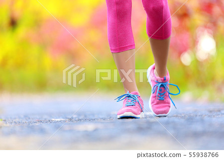 Jogging woman with athletic legs and running shoes 55938766