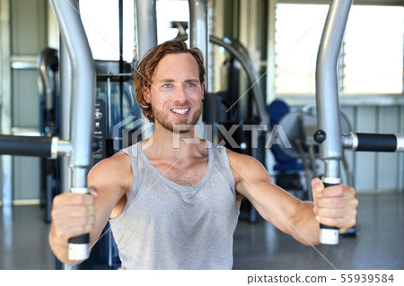 Man strength training hard at fitness gym center 55939584