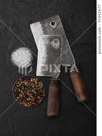 Vintage meat knife hatchets on black stone table Vintage meat knife hatchets on black stone table 55942677
