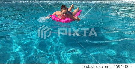Young woman laughs happily smiling swims in Young woman laughs happily smiling swims in 55944006
