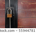 Golden padlock on old wooden door 55944781