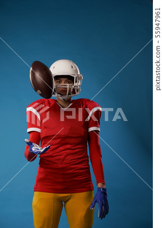 Photo of american female football player in white helmet, sportswear throwing ball Photo of american female football player in white helmet, sportswear throwing ball 55947961