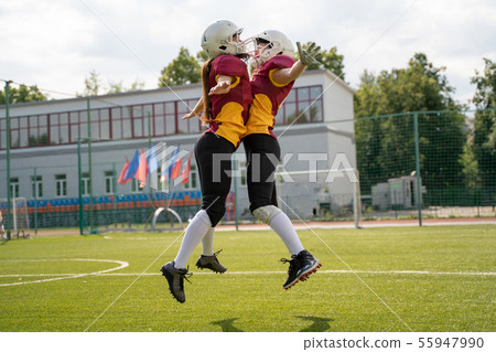 Photo of two rugby athletes jumping on playground 55947990