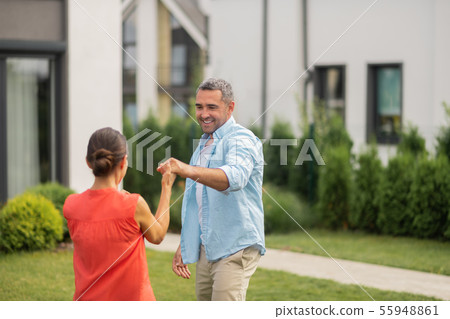 Husband dancing with his lovely dark-haired wife Husband dancing with his lovely dark-haired wife 55948861