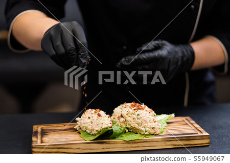 professional catering chef seasoning tuna salad 55949067