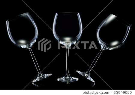 Set of empty glasses for red wine in a row isolated on black background. Set of empty glasses for red wine in a row isolated on black background. 55949090