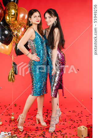 Group smiling woman posing surrounded by colorful Group smiling woman posing surrounded by colorful 55949256