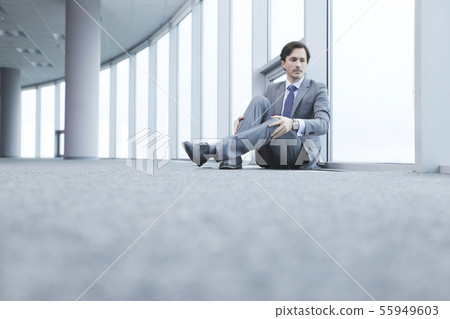 Businessman sitting on floor Businessman sitting on floor 55949603