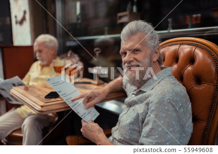 Bearded man choosing dish having lunch with friend 55949608