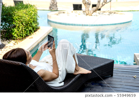 Asia woman sit on the sunbed Asia woman sit on the sunbed 55949659
