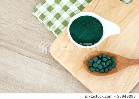 Close up a spirulina powder and spirulina pills Close up a spirulina powder and spirulina pills 55949898