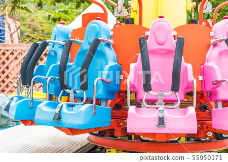 Colorful roller coaster seats at amusement park Colorful roller coaster seats at amusement park 55950171