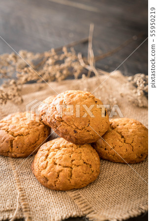 oatmeal raisin cookies on wood 55950219