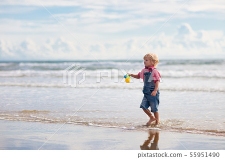 Kids play on tropical beach. Sand and water toy. 55951490