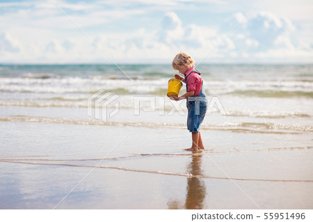 Kids play on tropical beach. Sand and water toy. Kids play on tropical beach. Sand and water toy. 55951496