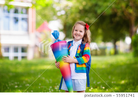 Little child with candy cone on first school day Little child with candy cone on first school day 55951741