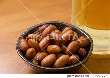 Boiled peanuts. A mug with a highball in the back of the photo. 55951776