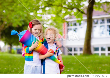 Kids with candy cone on first school day in 55951807