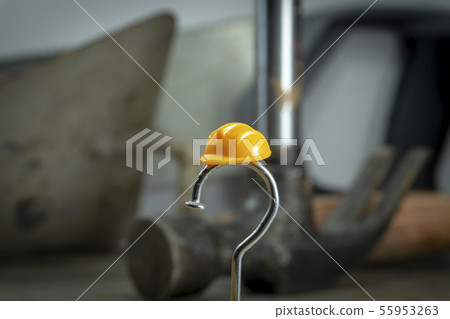 Carpentry nail shaped as question mark and helmet Carpentry nail shaped as question mark and helmet 55953263