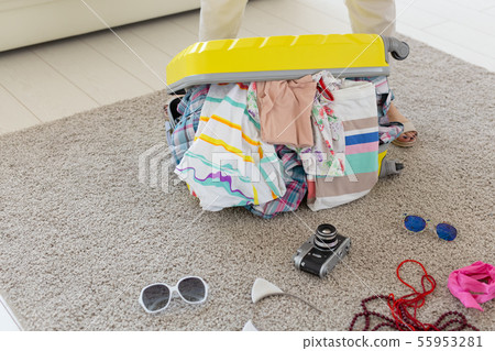 Vacation, travel and holidays concept - Woman trying to close suitcase with a lot of things Vacation, travel and holidays concept - Woman trying to close suitcase with a lot of things 55953281