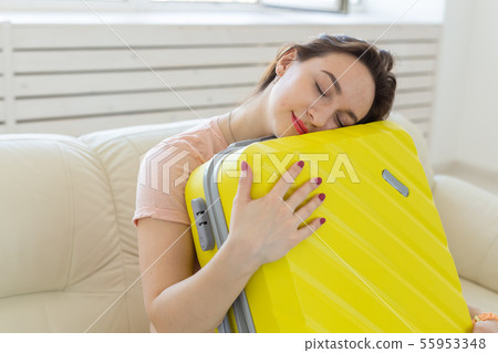 Trip, travel and holidays concept - woman is tired of collecting things for the trip Trip, travel and holidays concept - woman is tired of collecting things for the trip 55953348