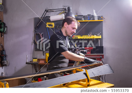 Repair, people concept - mechanic, man is rubbing a ski 55953370